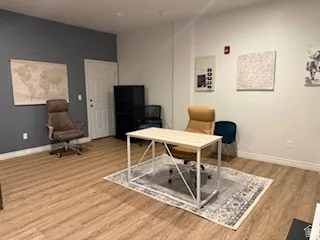 Office space featuring light wood-style flooring and baseboards