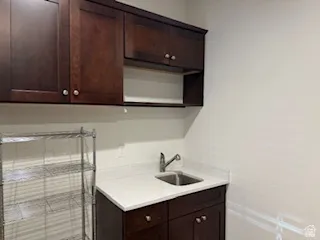 Kitchen featuring dark wood finish cabinetry and open shelves
