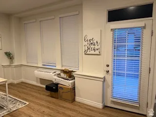 Entryway featuring dark wood-style floors and baseboards