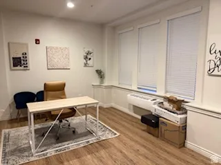 Office space featuring light wood finished floors and recessed lighting