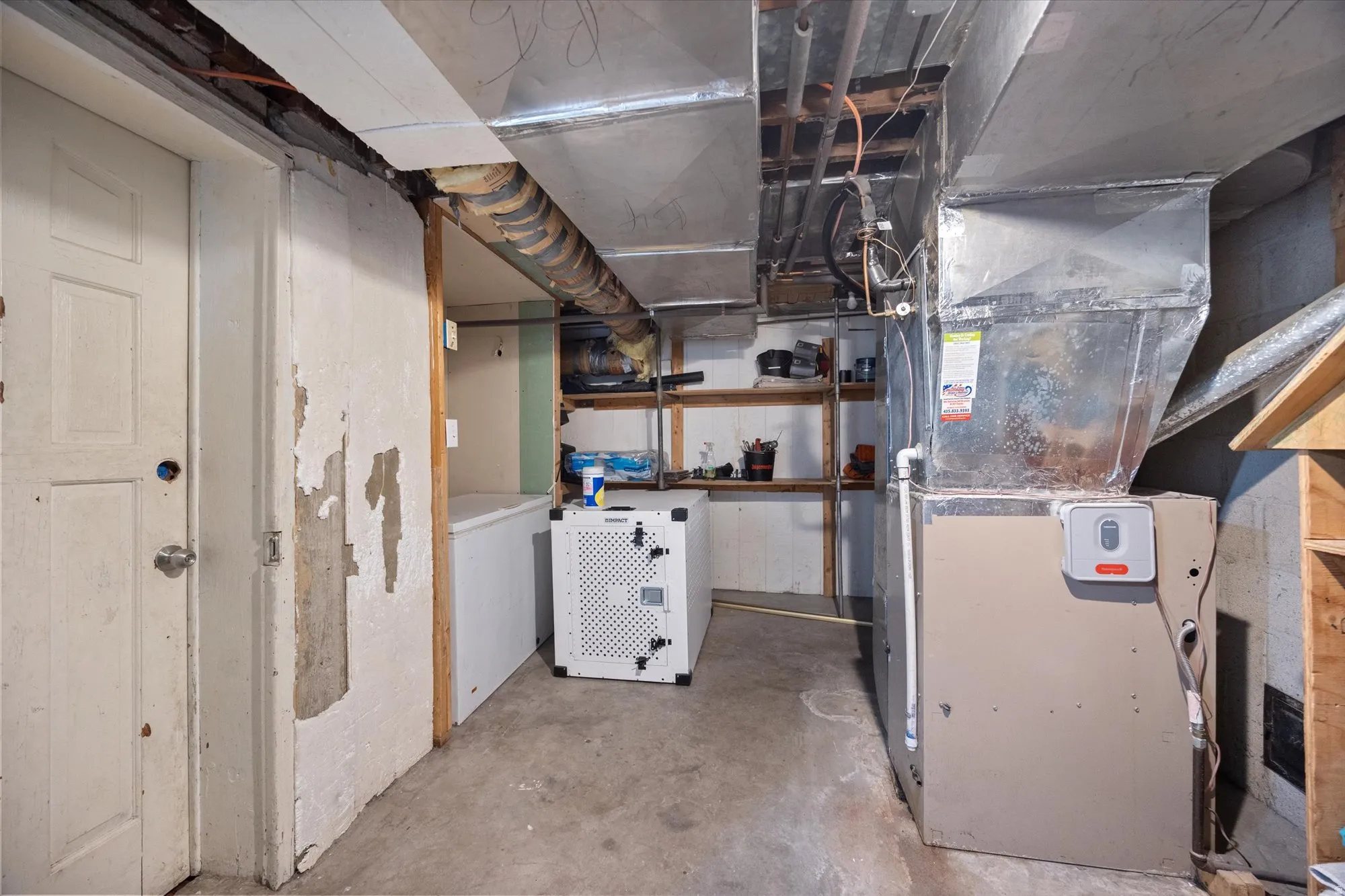 Unfinished below grade area with heating unit