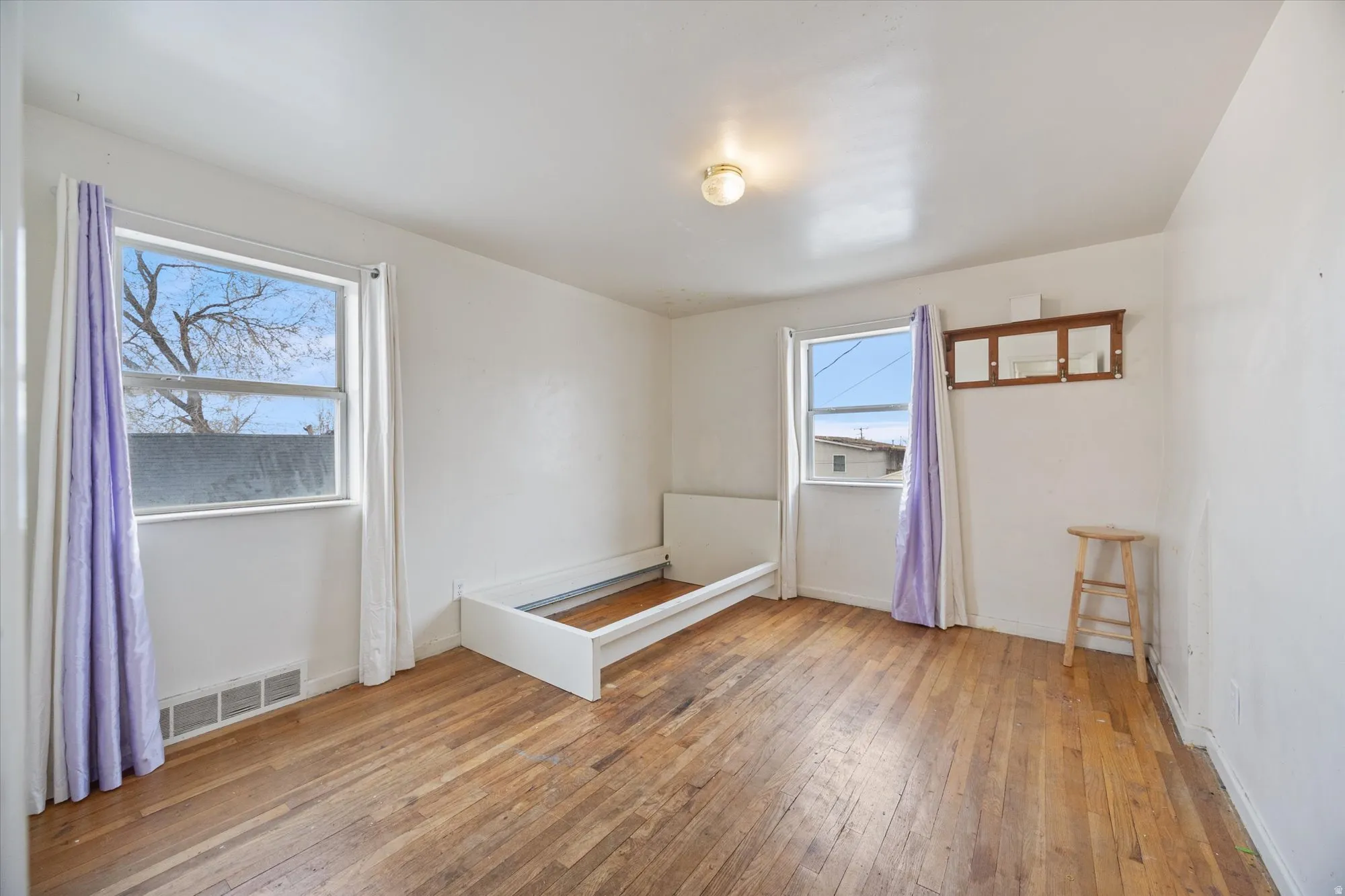 Empty room with light wood-style floors and baseboards