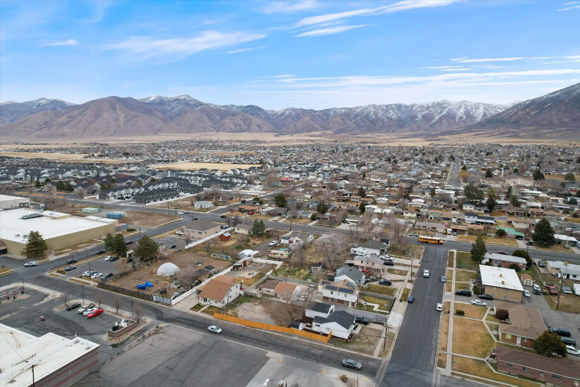Aerial perspective of suburban area featuring a mountain backdrop