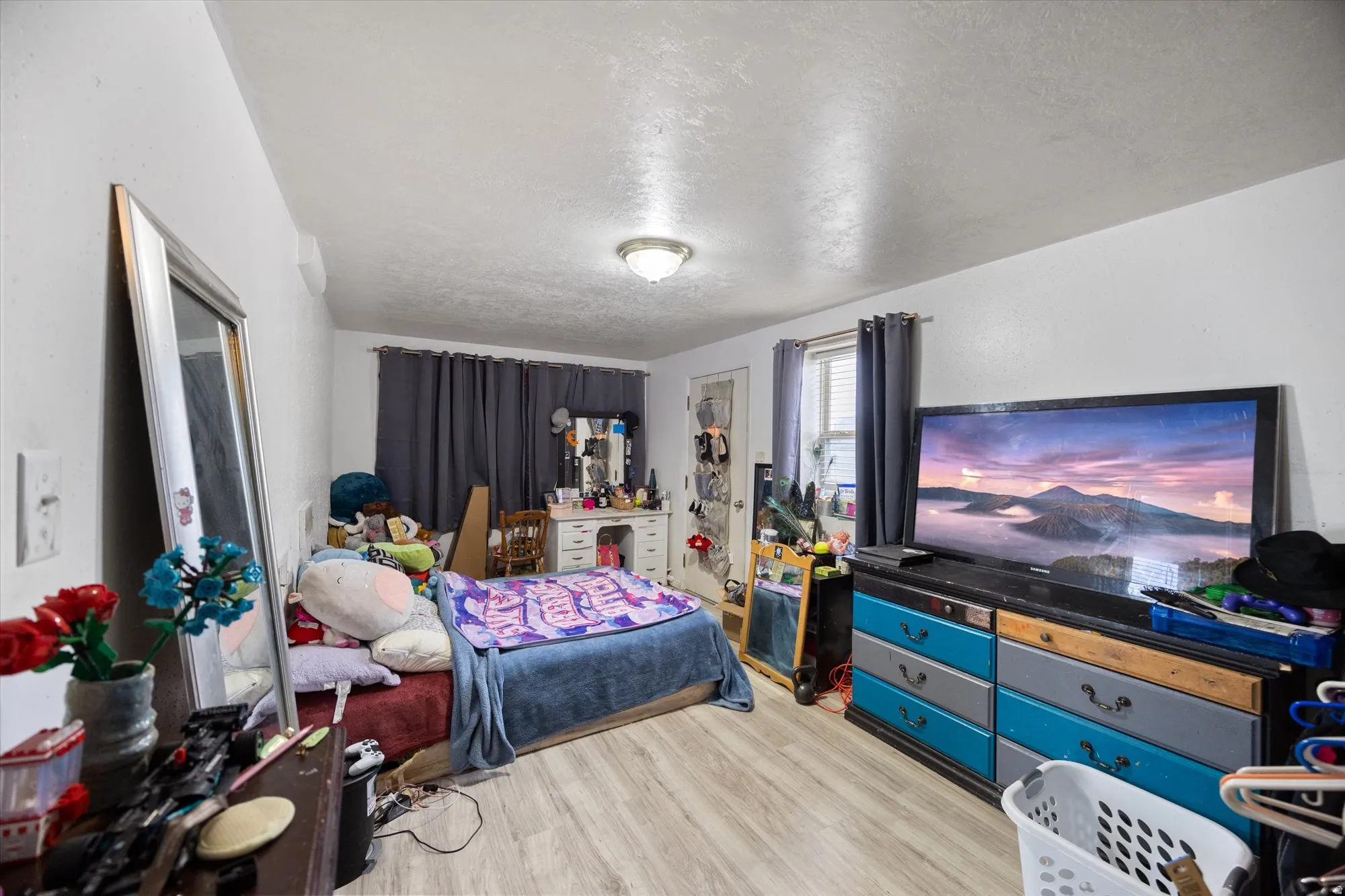 Bedroom featuring light wood-style flooring and a textured ceiling