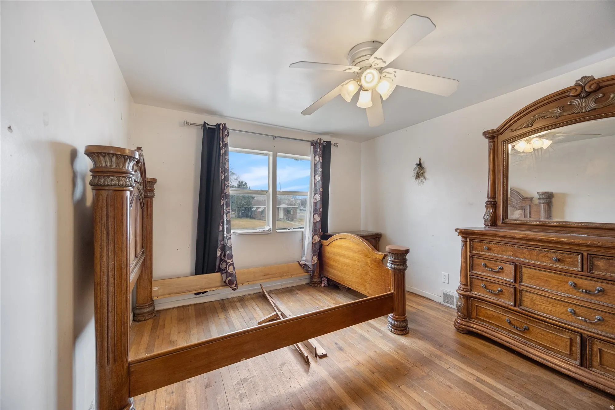 Bedroom featuring wood-type flooring and ceiling fan