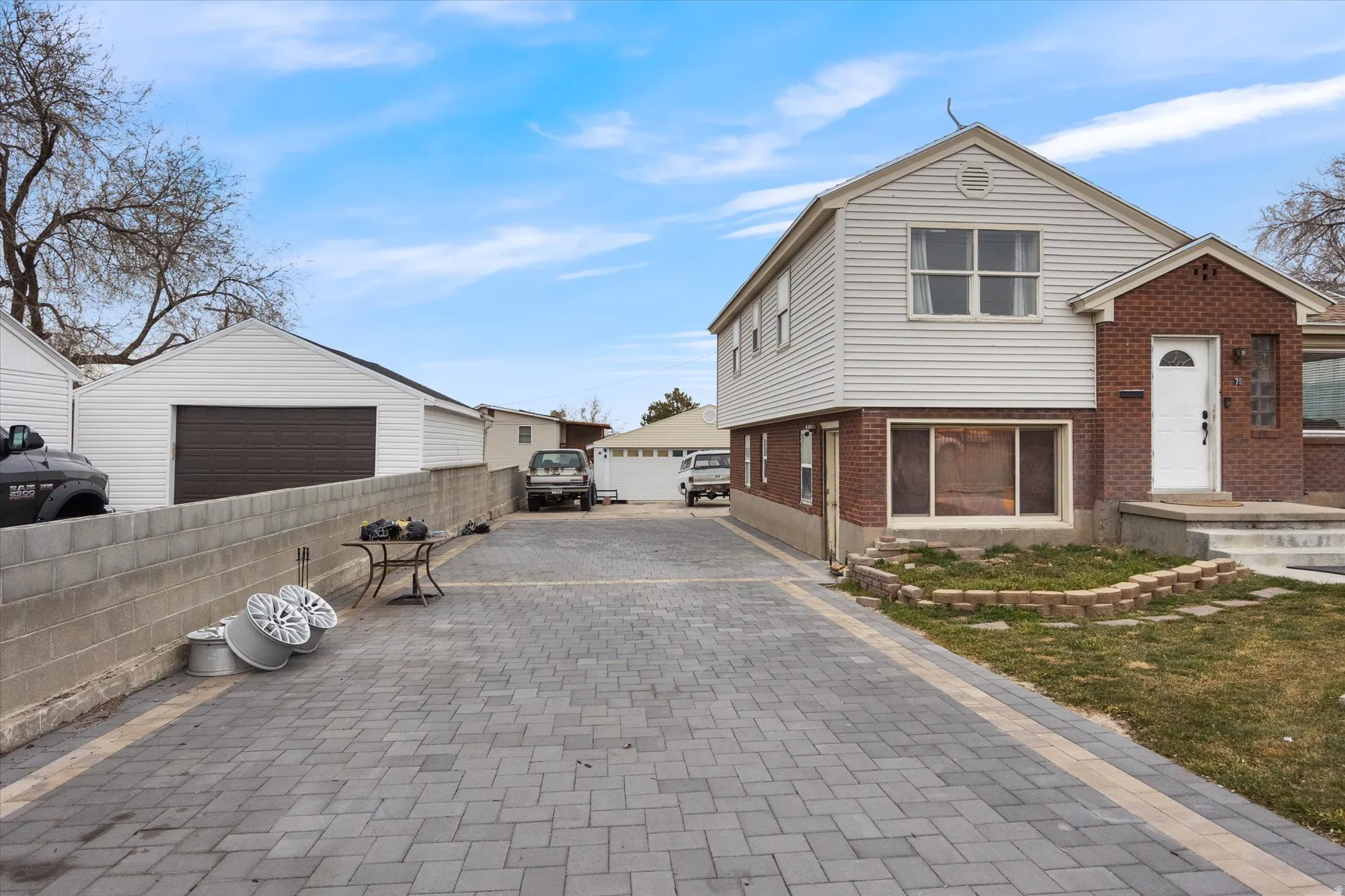 View of front of property with brick siding and an outdoor structure