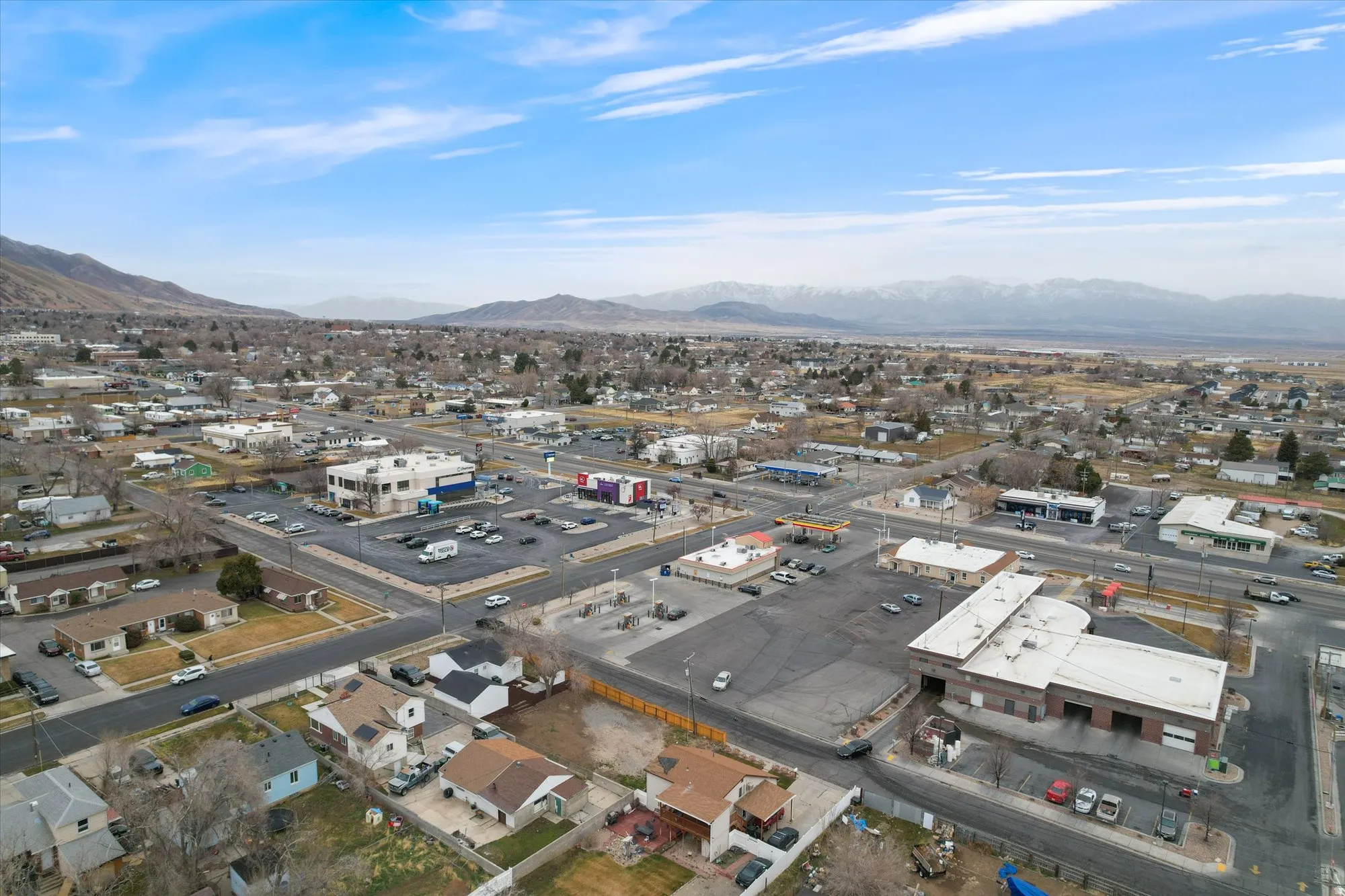 Aerial view of property and surrounding area with a mountain backdrop