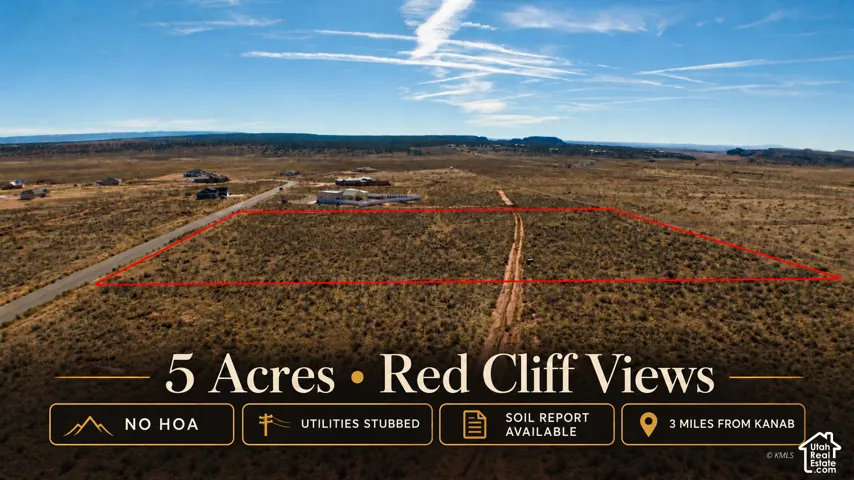 Five-acre parcel featuring prominent red cliff scenery, paved road access, and stubbed utilities