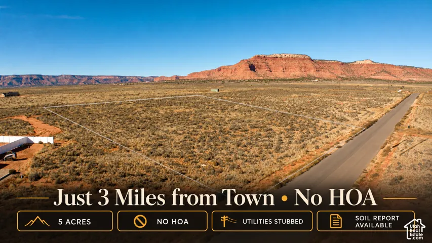 Five-acre parcel featuring prominent mesa terrain, paved road frontage, and utility stubs