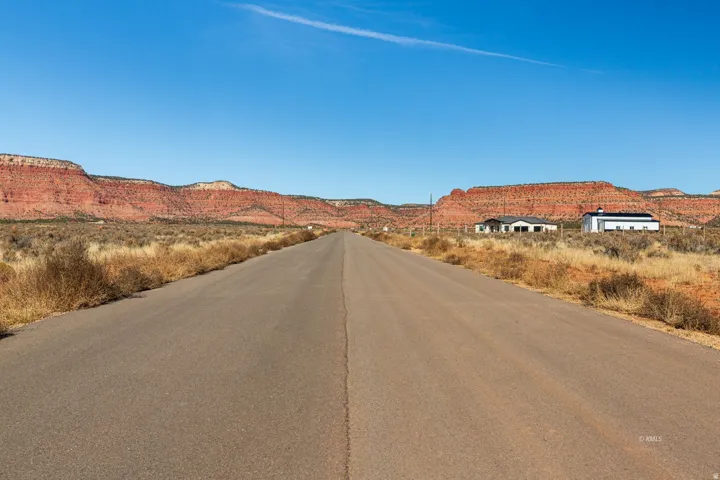 View of asphalt street featuring a mountain view