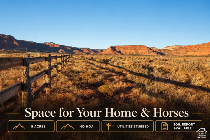 Expansive five-acre parcel featuring natural desert terrain, a split-rail wood perimeter fence, and prominent mountain backdrop