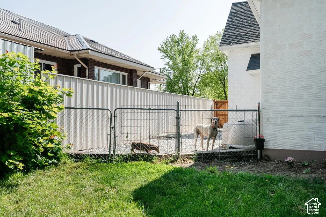 View of home's exterior with a gate and a shingled roof