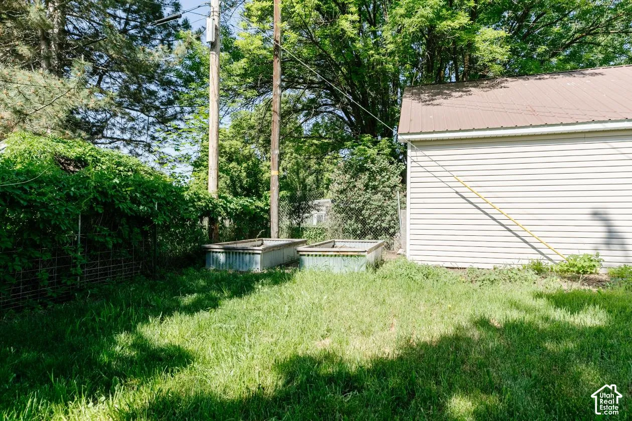 View of yard with a garden and view of scattered trees