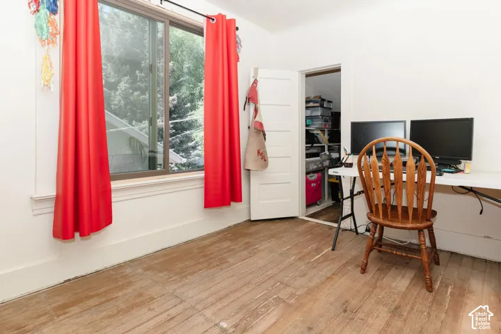bedroom/office featuring light wood-type flooring