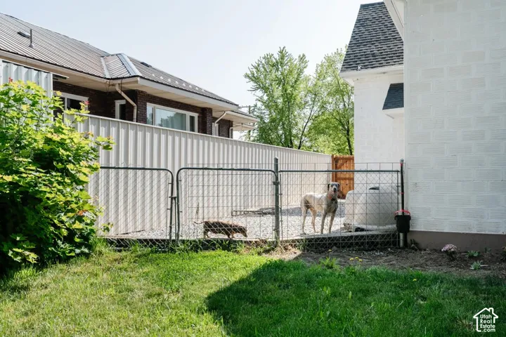 View of home's exterior with a gate and a shingled roof