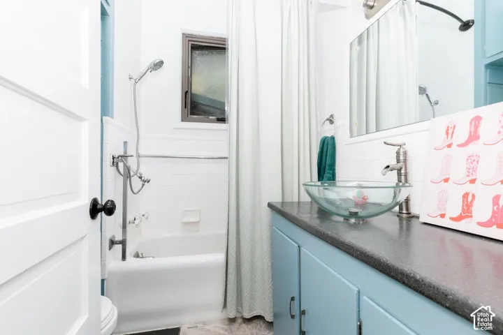 Bathroom featuring vanity and shower / bath combo