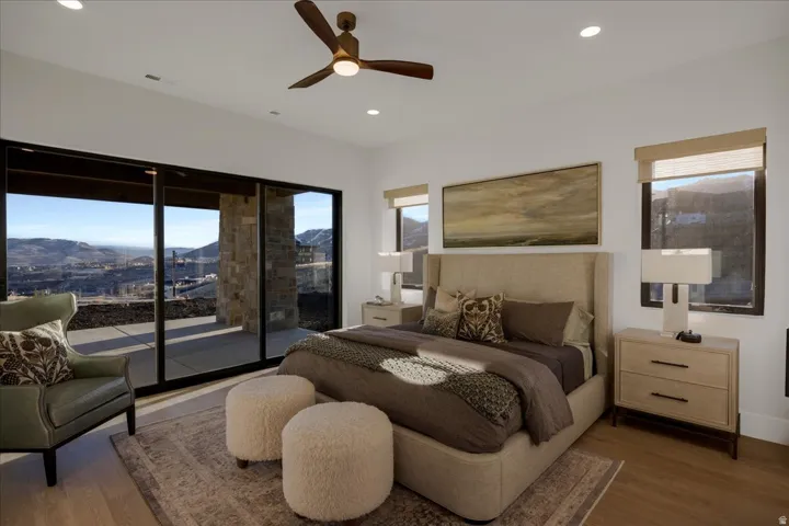 Bedroom featuring a mountain view, access to exterior, wood finished floors, ceiling fan, and recessed lighting