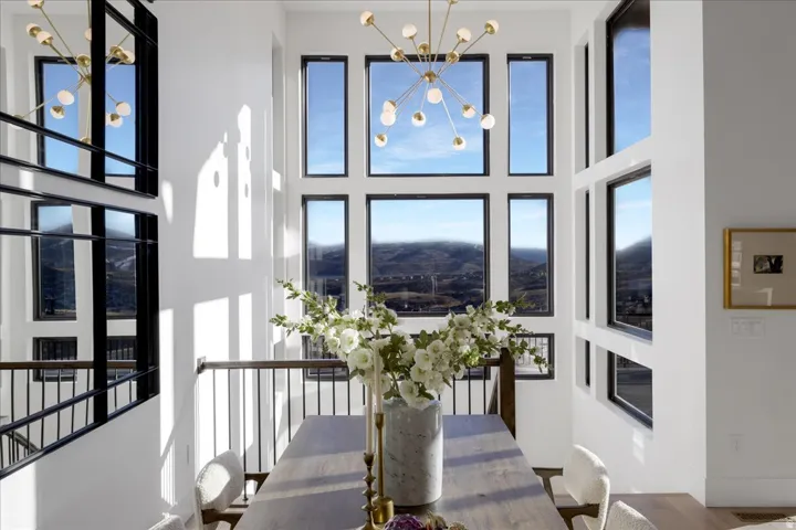 Dining area featuring hanging lights, a high ceiling, and healthy amount of natural light