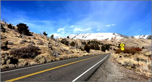 View of asphalt street with a mountain view