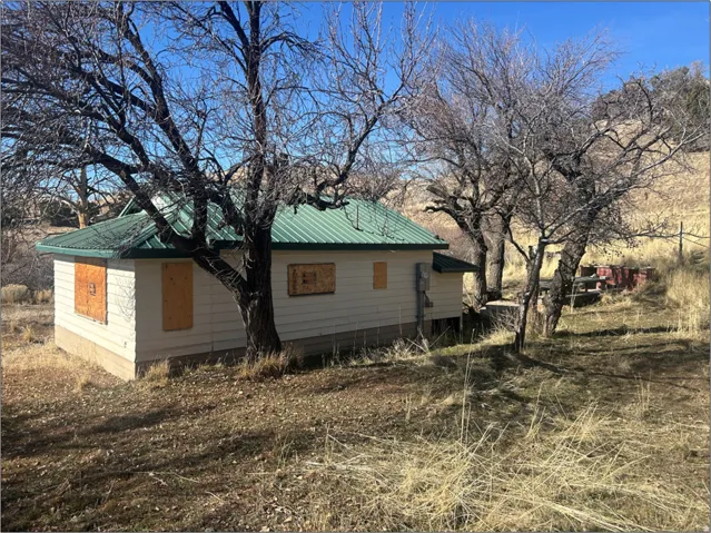 View of side of home with a metal roof