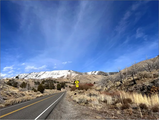 View of asphalt street with a mountain view