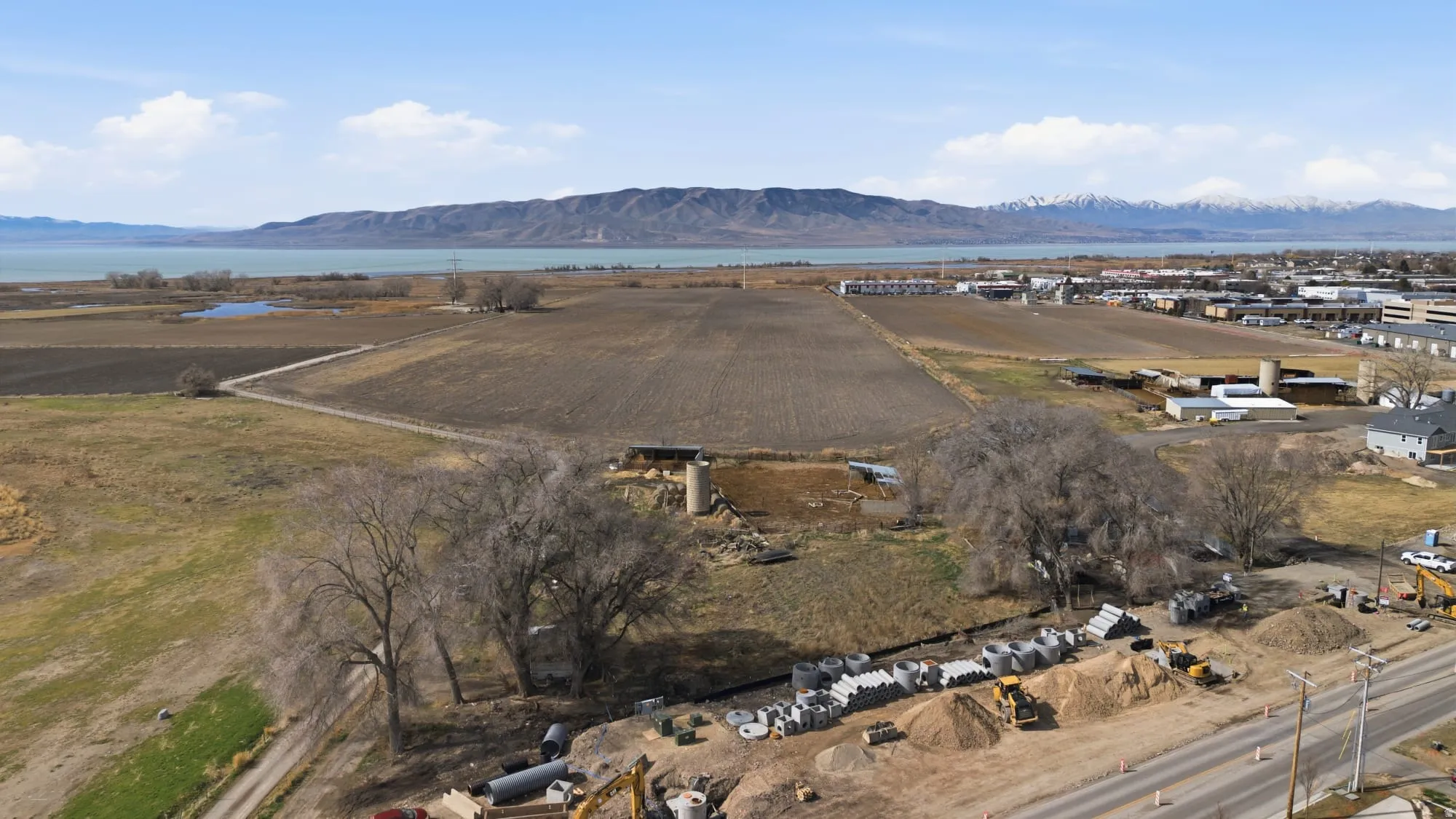 Overview of rural landscape featuring a mountain backdrop and rows of crops