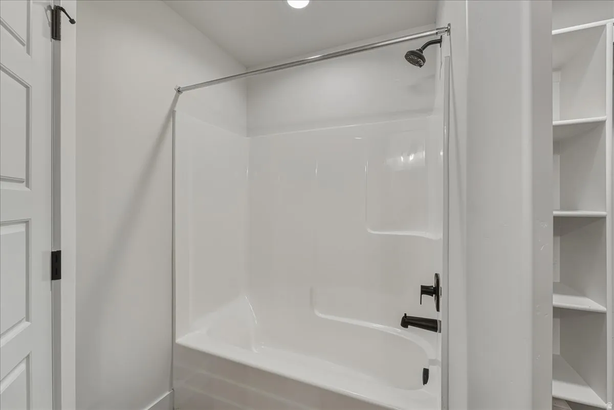 Full bath featuring bathing tub / shower combination