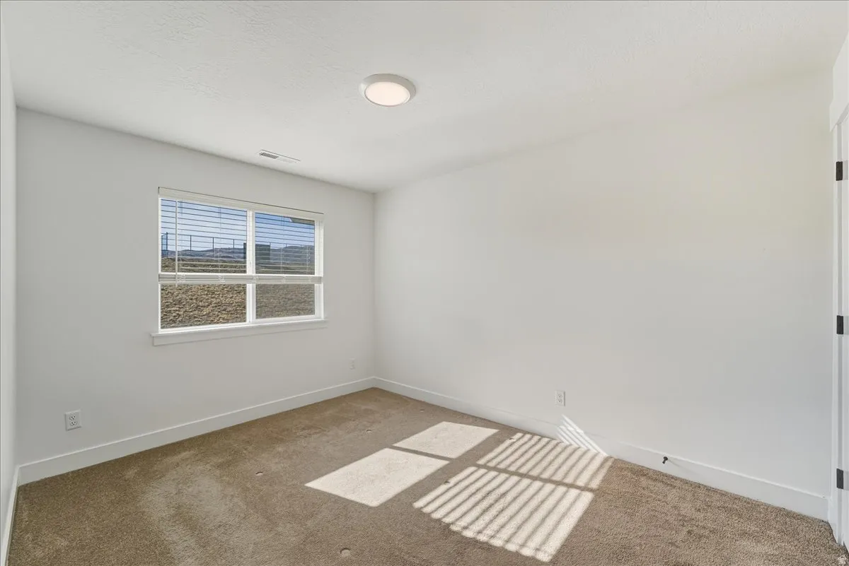 Unfurnished room featuring baseboards and carpet flooring