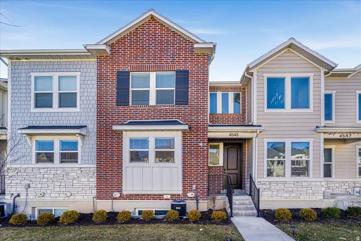 View of front facade featuring stone siding