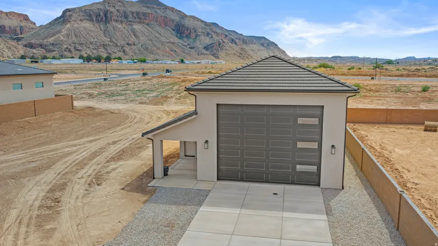 Garage featuring concrete driveway and a mountain view