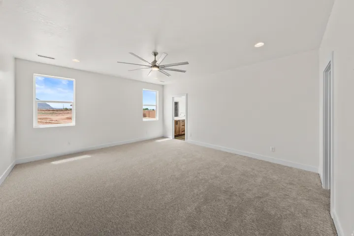 Spare room featuring light carpet, recessed lighting, and ceiling fan