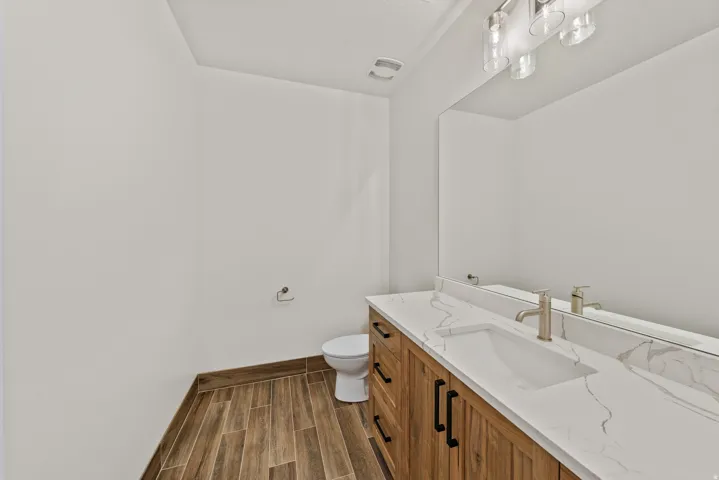 Bathroom featuring vanity and wood finish floors