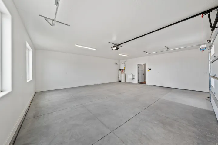 Garage featuring a sink and baseboards