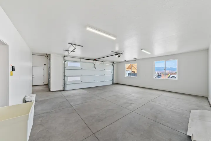 Garage featuring baseboards