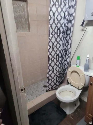 Full bathroom with a stall shower and wood finished floors