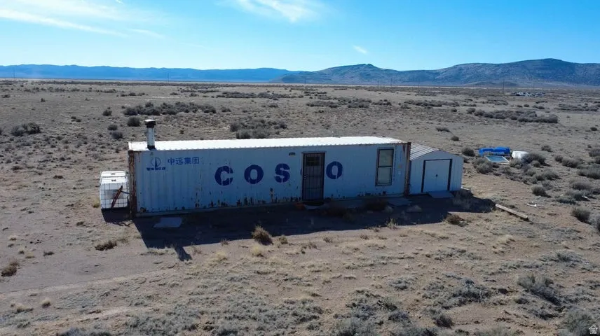 Manufactured / mobile home featuring a desert view, a mountain view, a rural view, and a storage shed