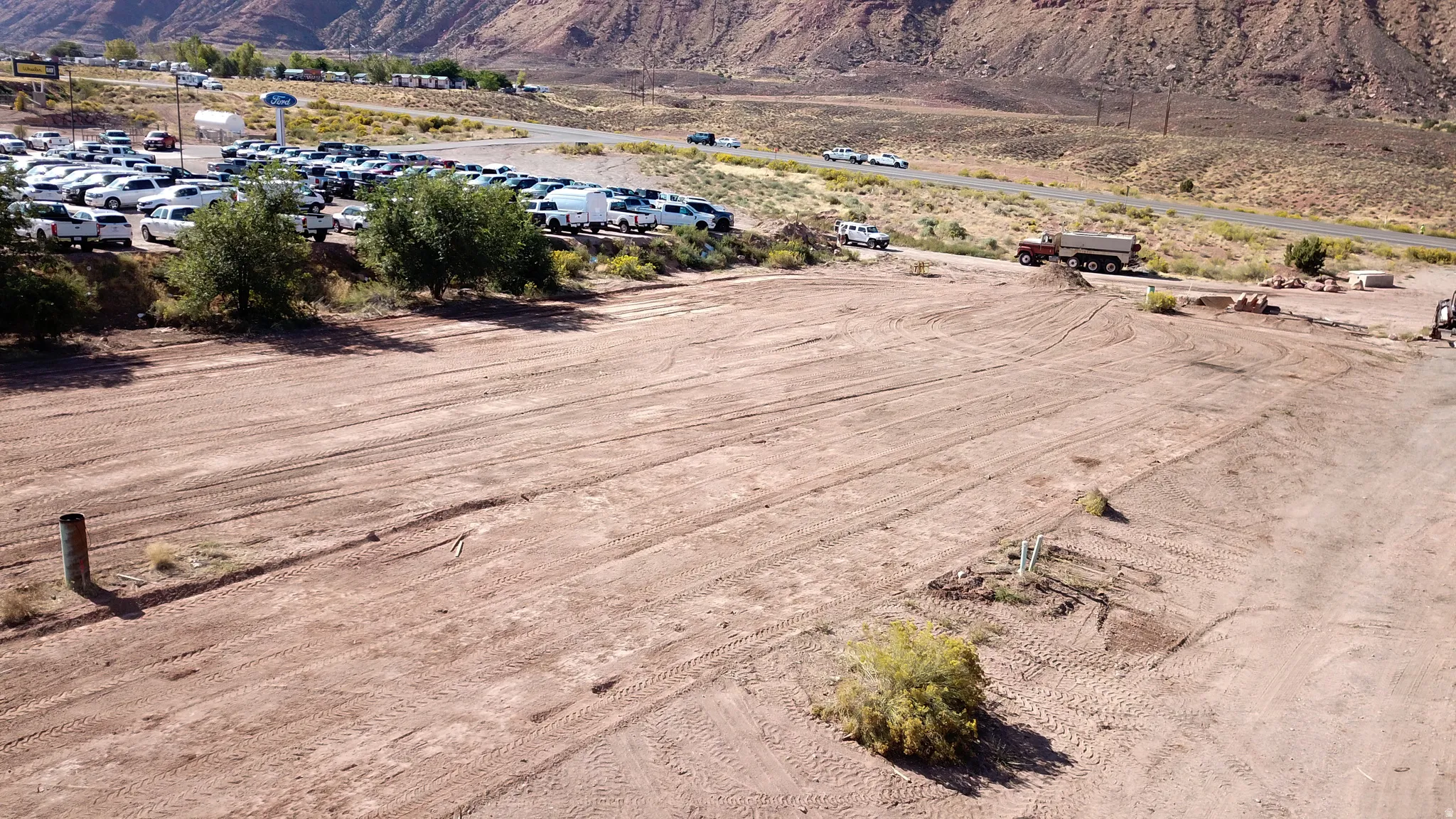 Aerial overview of property's location featuring a mountainous background and rural landscape