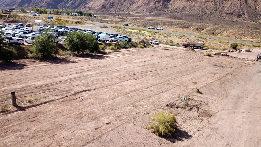 Aerial overview of property's location featuring a mountainous background and rural landscape