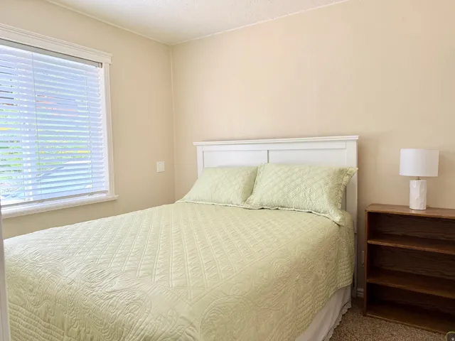 Carpeted bedroom with a textured ceiling