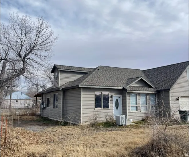 View of front of property with a shingled roof