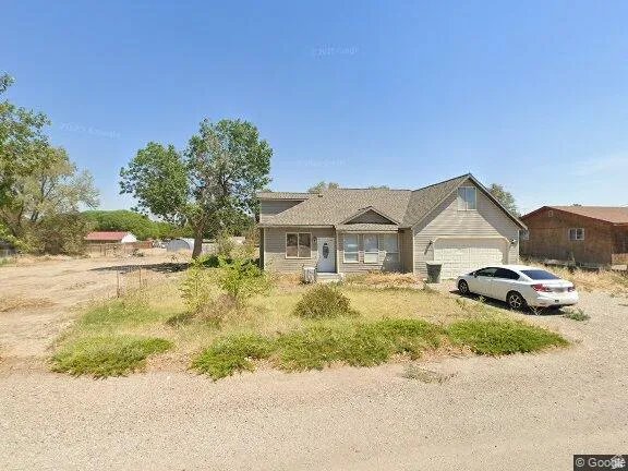 View of front of home with an attached garage and driveway