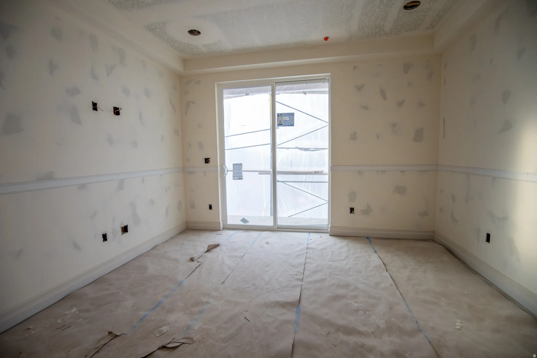 Unfurnished room with wallpapered walls