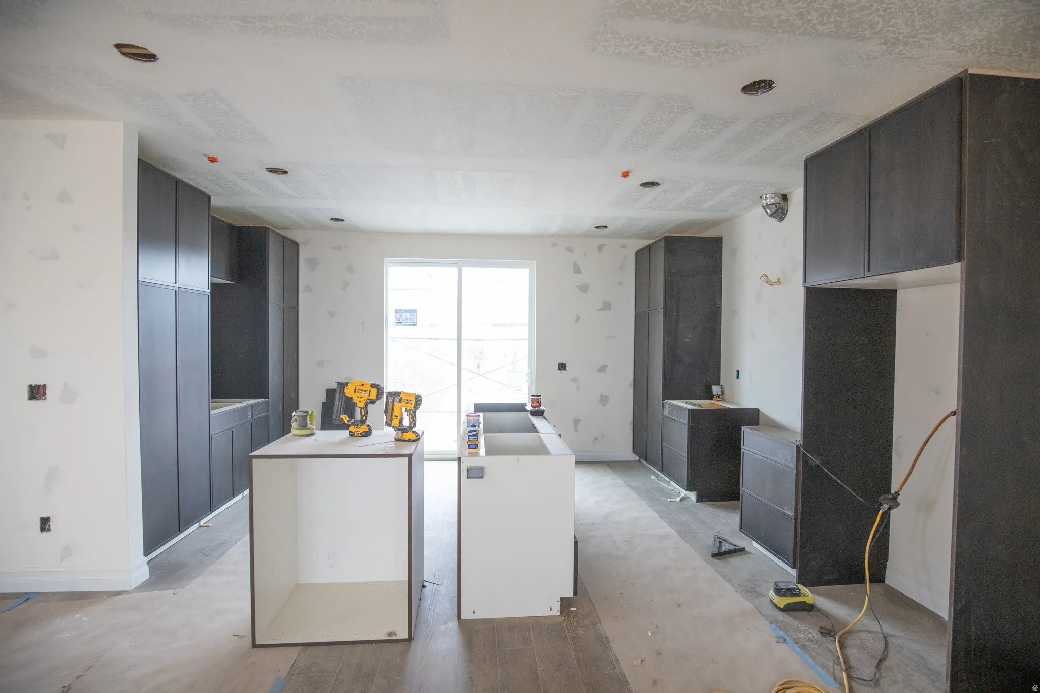 Kitchen featuring a center island and wallpapered walls