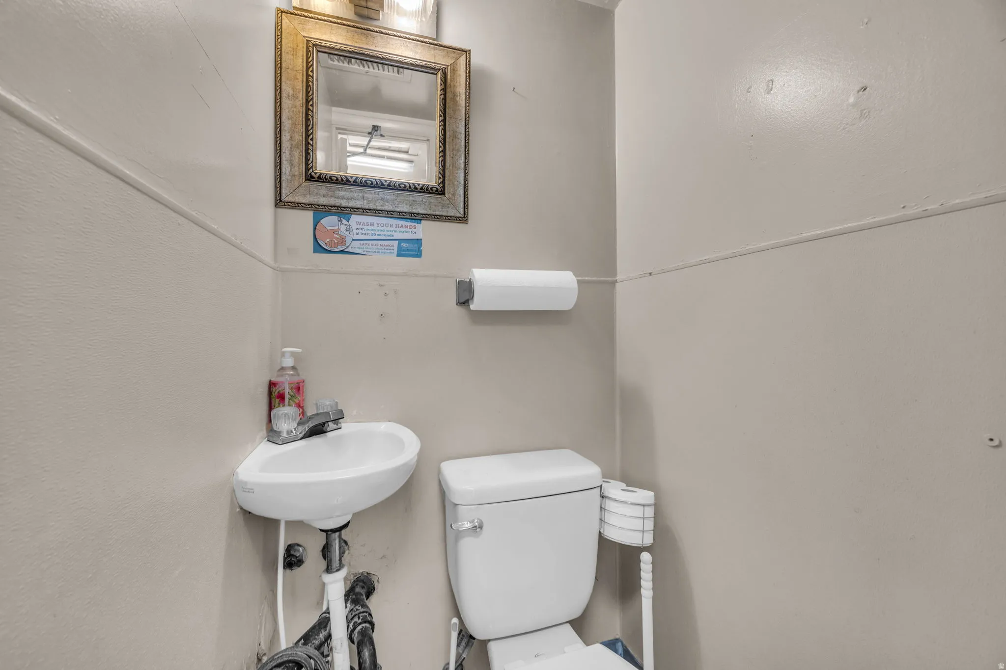 Half bath featuring toilet and a sink