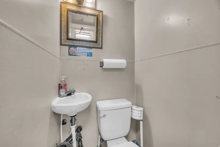 Half bath featuring toilet and a sink