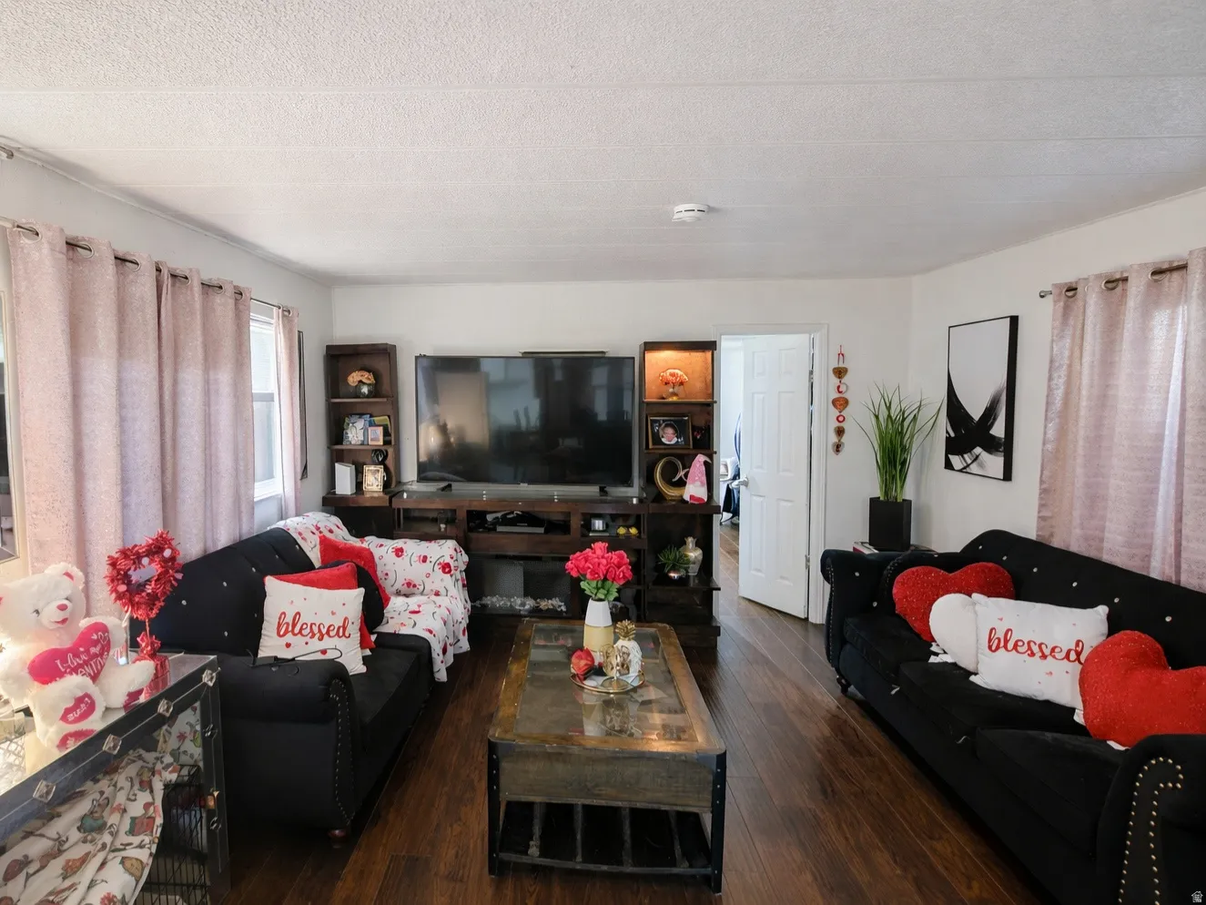 Living area with hardwood / wood-style floors and a textured ceiling