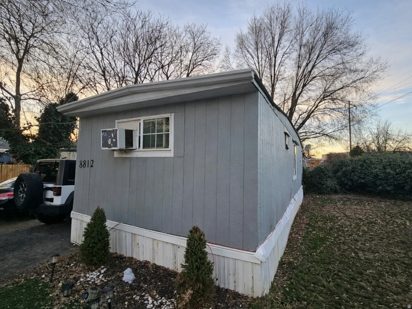 View of side of home featuring an outdoor structure