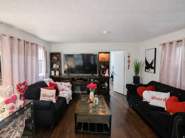 Living area with hardwood / wood-style floors and a textured ceiling
