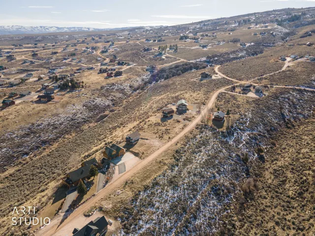 Aerial view of property and surrounding area with rural landscape and a mountain backdrop