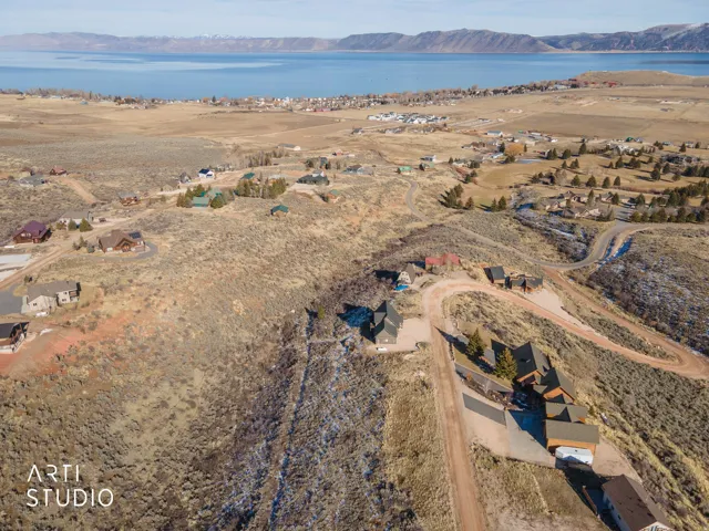 Aerial overview of property's location with nearby suburban area and a water and mountain view